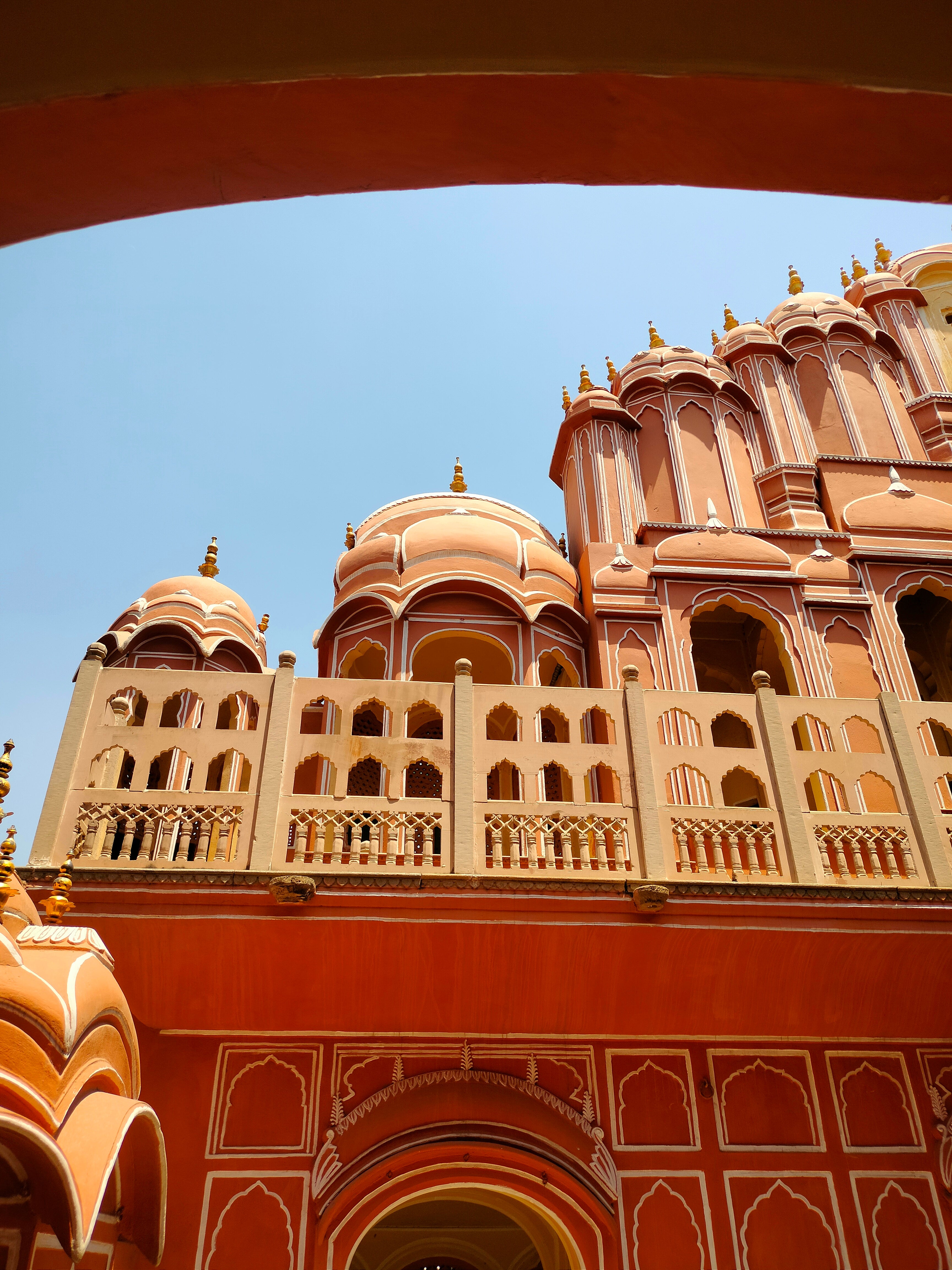 Pink architectural building with intricate designs under a clear blue sky